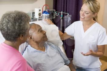 Royalty Free Photo of a Doctor With a Couple in the Hospital