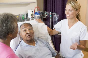 Royalty Free Photo of a Couple Talking to a Doctor