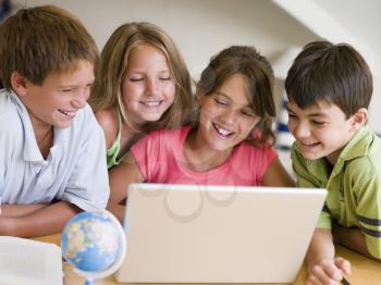 Royalty Free Photo of a Group Of Children With a Laptop