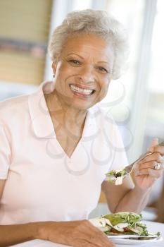 Royalty Free Photo of a Woman Enjoying a Salad