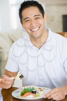 Royalty Free Photo of a Man Eating With Chopsticks