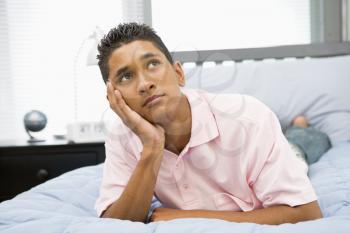 Royalty Free Photo of a Boy Lying on a Bed