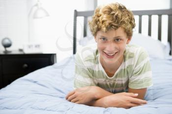 Royalty Free Photo of a Boy Lying on the Bed