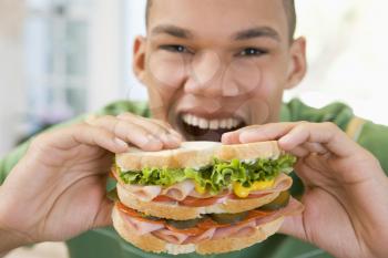 Royalty Free Photo of a Boy Eating a Sandwich
