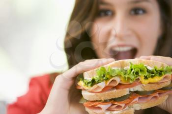Royalty Free Photo of a Girl Eating a Sandwich