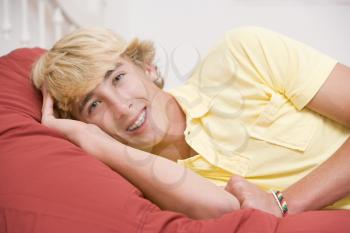 Royalty Free Photo of a Boy Lying on a Bed