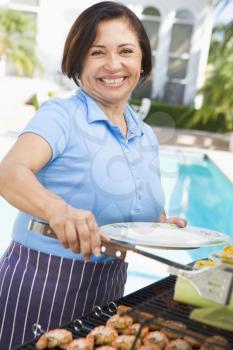 Royalty Free Photo of a Woman Barbecuing