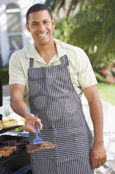 Royalty Free Photo of a Man Barbecuing