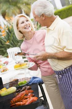 Royalty Free Photo of a Couple Barbecuing