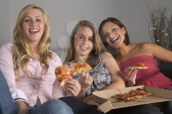 Royalty Free Photo of Girls Eating Pizza