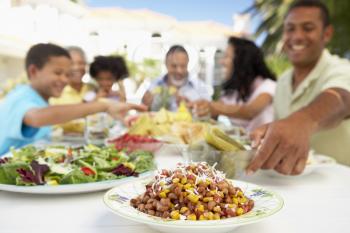 Royalty Free Photo of a Family Eating Outside