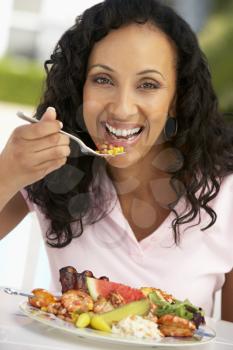 Royalty Free Photo of a Woman Eating Outside