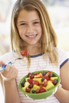 Royalty Free Photo of a Girl Eating Fruit Salad