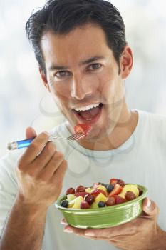 Royalty Free Photo of a Man Eating Fruit