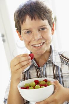 Royalty Free Photo of a Boy Eating Fruit