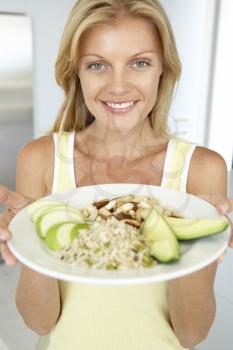 Royalty Free Photo of a Woman Holding a Plate of Healthy Food