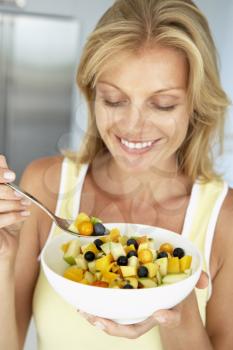 Royalty Free Photo of a Woman With Fruit Salad