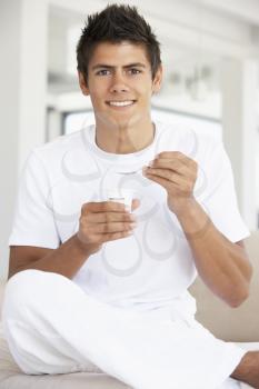 Royalty Free Photo of a Man Eating Yogourt