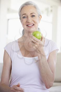 Royalty Free Photo of a Woman Eating an Apple