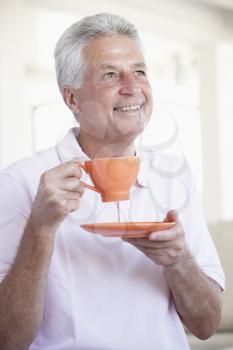 Royalty Free Photo of a Man With an Orange Teacup