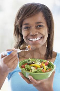 Royalty Free Photo of a Teenager Eating Salad
