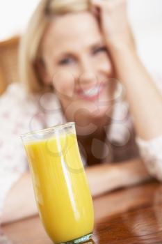 Royalty Free Photo of a Woman Looking at Orange Juice
