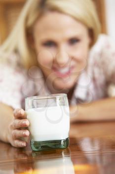 Royalty Free Photo of a Woman Looking at a Glass of Milk