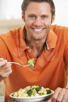 Royalty Free Photo of a Man Eating a Meal