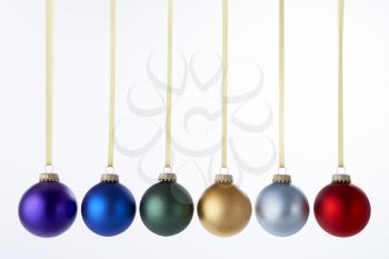 Royalty Free Photo of a Line of Hanging Christmas Ornaments
