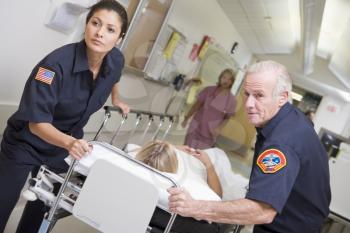 Royalty Free Photo of Paramedics Rushing in a Hospital