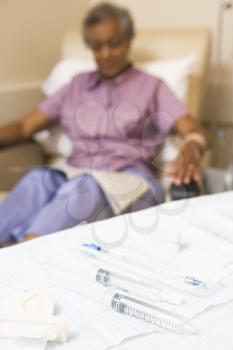 Royalty Free Photo of a Woman Behind a Table of Syringes