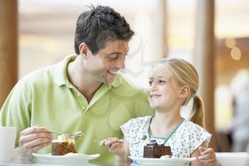 Royalty Free Photo of a Father and Daughter Having Cake at a Mall