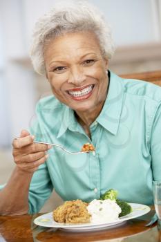 Royalty Free Photo of a Woman Enjoying a Meal