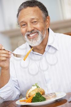 Royalty Free Photo of a Man Enjoying a Meal