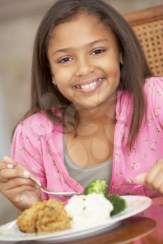 Royalty Free Photo of a Young Girl Having a Meal