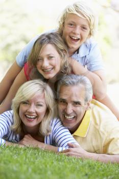 Royalty Free Photo of a Family Lying on the Ground