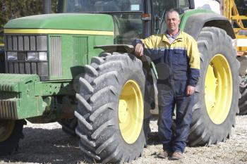 Royalty Free Photo of a Farmer With a Tractor