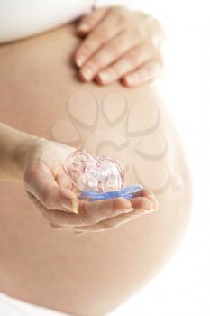 Royalty Free Photo of a Woman Holding Pink and Blue Soothers