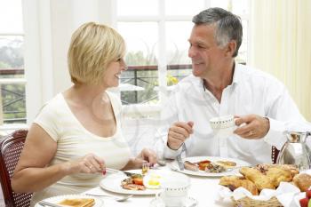 Royalty Free Photo of a Couple Having Breakfast at a Hotel