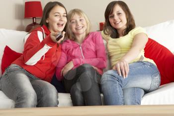 Royalty Free Photo of Three Girls Watching TV