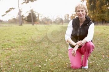 Royalty Free Photo of a Woman in Exercise Clothes in a Park
