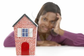 Royalty Free Photo of a Woman Looking at a Small House