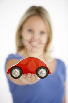 Royalty Free Photo of a Woman Holding a Toy Car