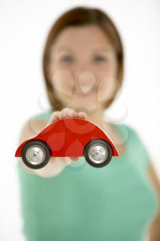 Royalty Free Photo of a Woman With a Tiny Car