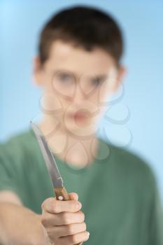 Royalty Free Photo of a Boy Holding a Knife