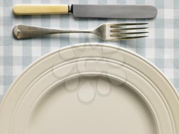 Royalty Free Photo of a Plate With a Fork and Knife