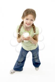 Studio Portrait of Smiling Girl Holding Glass of Milk