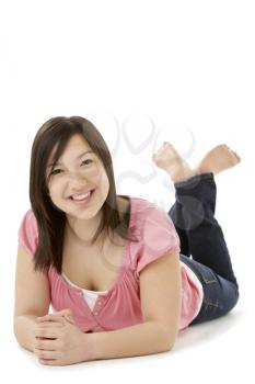 Royalty Free Photo of a Teenage Girl Lying on Her Stomach