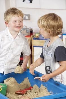 Royalty Free Photo of Two Children Playing in Sand