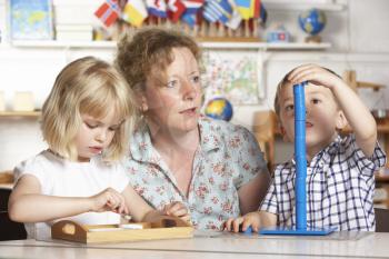 Royalty Free Photo of an Adult With Two Preschool Children